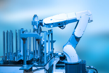 Industry concept and blue tone of automated robot arm in production line of smart factory