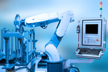 Industry concept and blue tone of automated robot arm with control panel in production line of smart factory