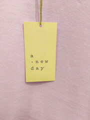 Tag With Upbeat Message Against Lavender Cloth Background