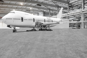 Fototapeta premium Airplane are performing repairs, fixes, modernization and renovation in the aviation hangar