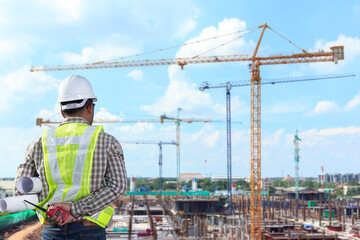 Engineer looking at large building construction site