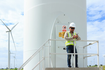 Engineer use radio communication for control working at wind turbine power plant
