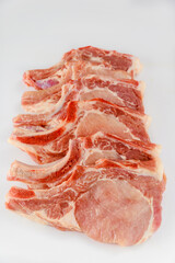 Raw pork chops bone in isolated on white background.