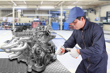 Auto mechanics holding a tool for repair engine car at repair shop service