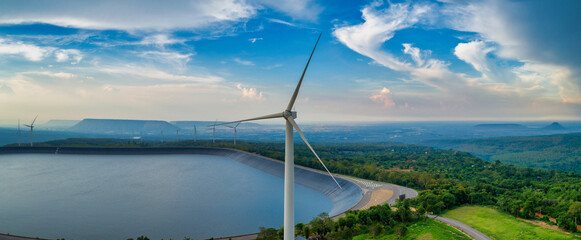 Aerial view of panorama view wind turbine construction on mountain with beauty blue sky and cloudy