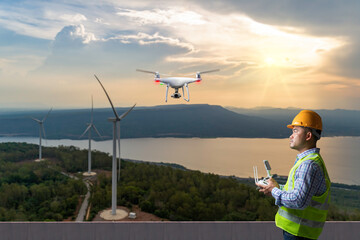 Drone operated by engineer during maintenance and inspection of a wind turbine on mountain in sunset sky. green ecological power energy generation.
