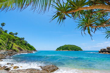 Fototapeta na wymiar Leaves frame with Summer sea beach Amazing sea clear blue sky and clouds Wave crashing on seashore tree leaves beautiful leafs frame over sea Copy space