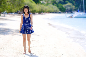 woman in blue dress on the beach, at leela beach koh phangan ,suratthani,thailand	
