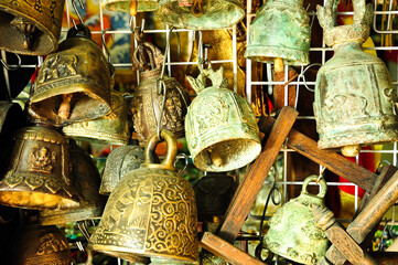 A close-up of golden bells for sale in a market.
