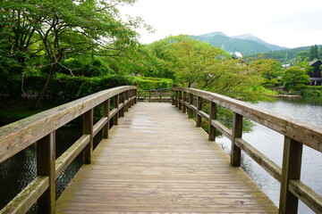 Fototapeta na wymiar Wooden Bridge over Kinrin Lake in Yufuin, Oita, Japan - 日本 大分県 湯布院 金鱗湖 木製の橋
