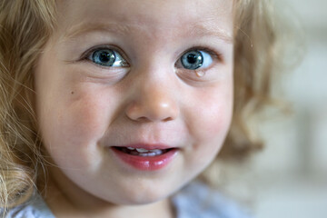 Portrait of a cute little girl with a tear in her eyes.