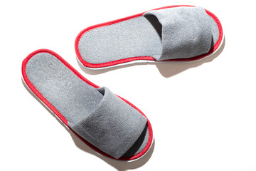 Gray one-off slippers for hotel on a white background
