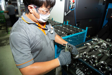 Hand of technician wearing cloth gloves was using a digital vernier tool to measure the width