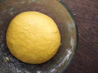 Yellow pumpkin bread dough in mixing bowl