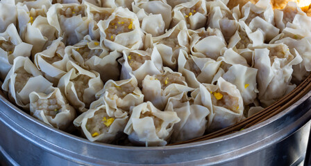 pile of dumplings in a steaming pot with steaming steam. healthy traditional food dumplings, tofu and fish balls