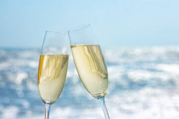 two glasses of champagne on the sea beach