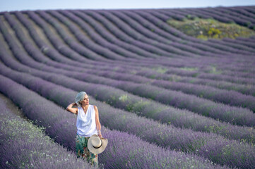 White haired woman with hatin the lavender fields