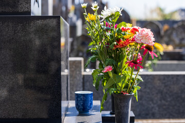 墓に手向けられた花と茶