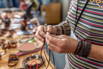 Craftsman working with leather in his workshop