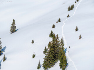 Winter landscape in the mountains with a footpath made through the fresh snow