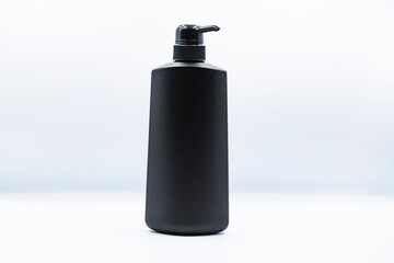 Black plastic bottle with dispenser pump for liquid soap , gel, lotion, cream, shampoo, bath foam and other cosmetics. Blank product packaging mockup template design for mock up, ads and marketing.