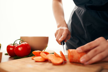 cutting carrots on a cutting board with a knife kitchen cooking