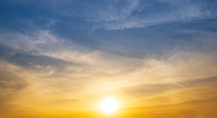 The sunrise shines on the sky covered with clouds.