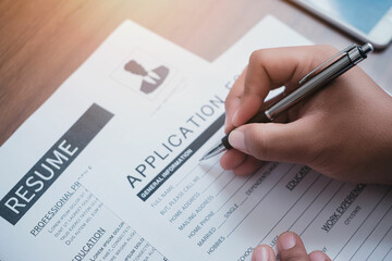 Online Web Job Application Form Concept. Close-up of unrecognizable businessman sitting at table with making notes in application form.