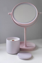 pastel interior with pink mirror and candle