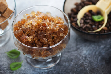 Closeup of a glass bowl with coffee granita on a dark-grey stone background, selective focus, studio shot