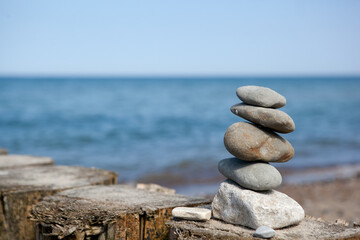 stones stacked on top of each other against the background of the sea