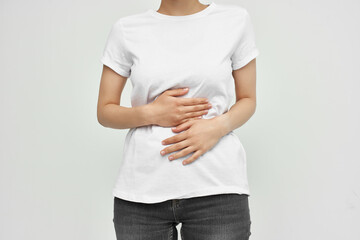 woman with abdominal pain diarrhea health problems light background
