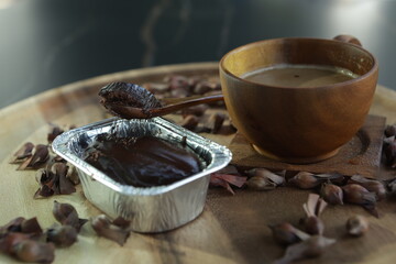 Brown cake and coffee on wooden background