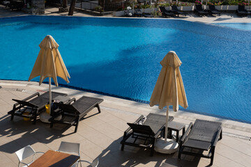 empty sunbeds on the sea shore, top view