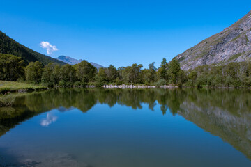 Fototapeta na wymiar the sky reflecting in the waters of the lake of Bessans in Haute Maurienne in the French Alps
