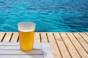 beer mug standing on wooden floor by the beach