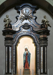 marble altar to the Virgin Mary, surmounted by two angels.