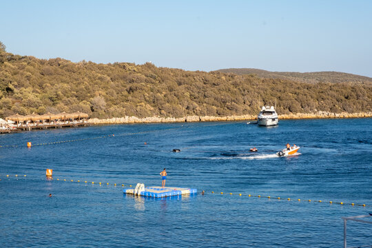 man standing on plastic pontoons over sea at resort