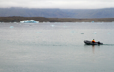 Boat going through a lagoon in Iceland with a retreating glacier