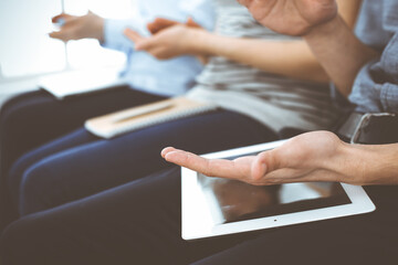 Business people clapping at meeting or conference, close-up of hands. Group of unknown businessmen and women in modern white office. Success teamwork, corporate coaching and applause concept