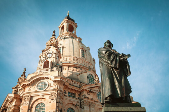 Statue of Martin Luther and Church Frauenkirche on background in Dresden