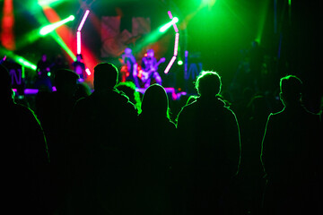Fototapeta na wymiar crowd at concert and silhouettes in stage lights