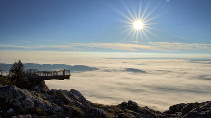 Sunrise in the alps over clouds and fog with skywalk