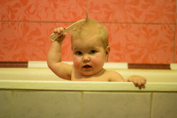 the kid bathes at home in the bath and made his own hair - mohawk