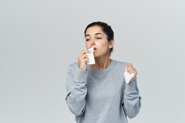 sick woman wiping her face with a handkerchief influenza infection