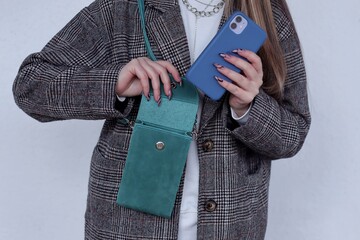 The girl puts the phone in her bag