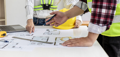 Two architect-engineers are consulting to modify the blueprints of the contracted house, they have a meeting to inspect the house designs before meeting with the client. Home design ideas.