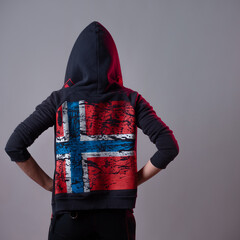 woman in a hooded sweatshirt with the flag of Iceland on the back,