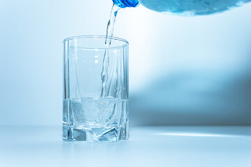 Pour mineral water into a glass.