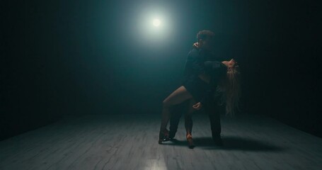 Experienced stage dancers spend time training, romantic atmosphere scene in a dark studio, beautiful blonde dancers practice going down to the first floor, slow motion deflection